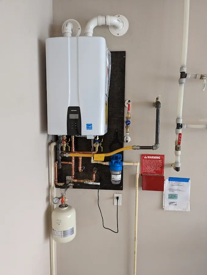 Professional plumber installing copper piping in a Choctaw home